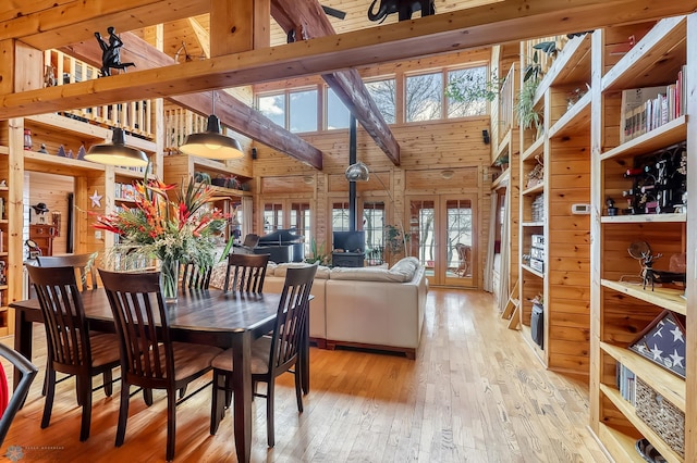 12104 County Highway 17, Lake View Twp, MN 56501 - dining area featuring high vaulted ceiling, hardwood / wood-style flooring, healthy amount of natural light, wooden walls, and french doors