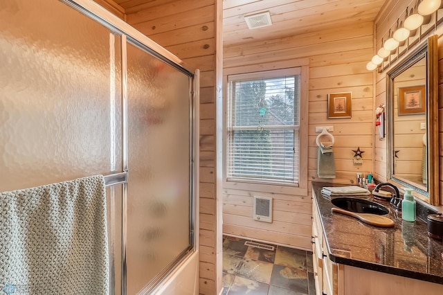 12104 County Highway 17, Lake View Twp, MN 56501 - full bath with wooden walls, vanity, shower / bath combination with glass door, and heating unit