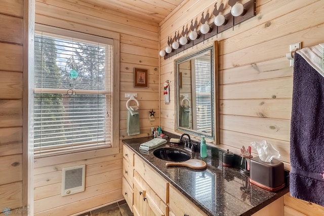 12104 County Highway 17, Lake View Twp, MN 56501 - bathroom featuring wood walls, vanity, plenty of natural light, heating unit, and wooden ceiling