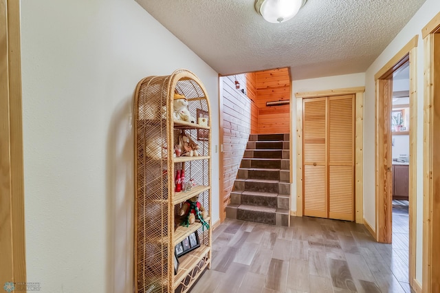 12104 County Highway 17, Lake View Twp, MN 56501 - stairs with wood finished floors and a textured ceiling