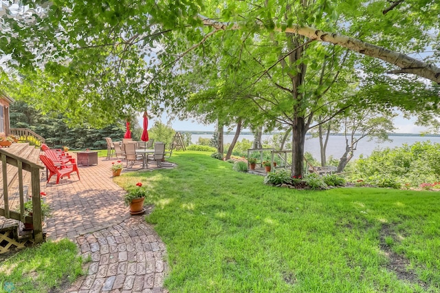 12104 County Highway 17, Lake View Twp, MN 56501 - view of grassy yard featuring a deck with water view and outdoor dining space