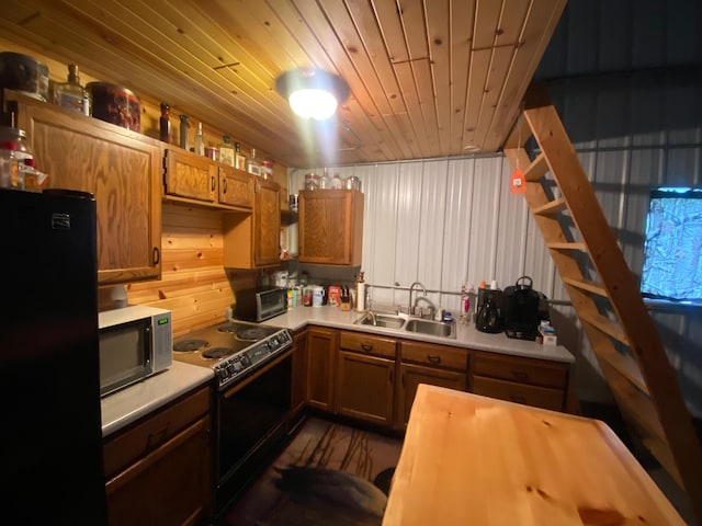 20668 County Road 41, Bremen Twp, MN 55795 - kitchen with black appliances, light countertops, and brown cabinetry