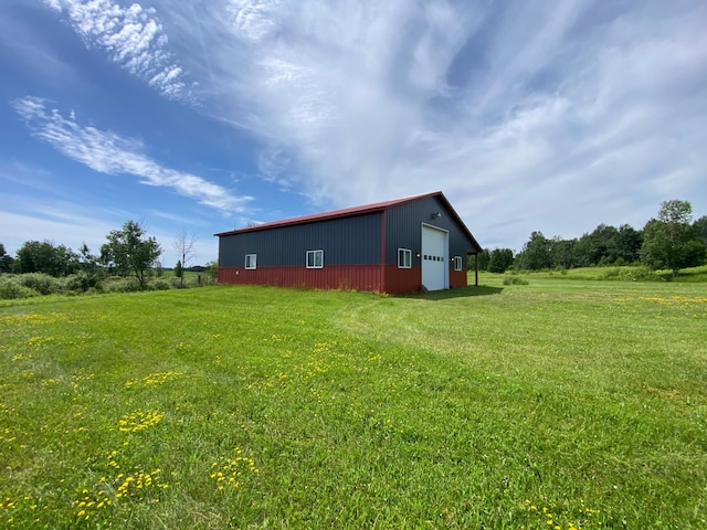 20668 County Road 41, Bremen Twp, MN 55795 - view of grassy yard featuring a garage, an outdoor structure, and driveway