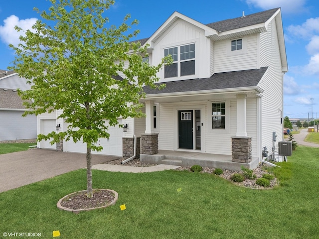 15742 Everglade Ave, Apple Valley, MN 55124 - craftsman-style home with a porch, driveway, a front yard, roof with shingles, and stone siding