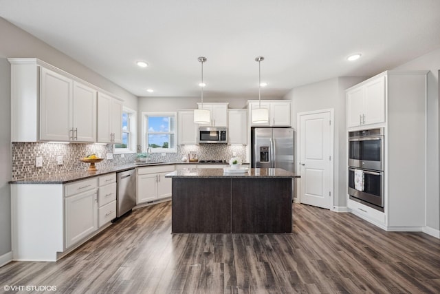 15742 Everglade Ave, Apple Valley, MN 55124 - kitchen with stainless steel appliances, dark wood finished floors, tasteful backsplash, white cabinetry, and recessed lighting