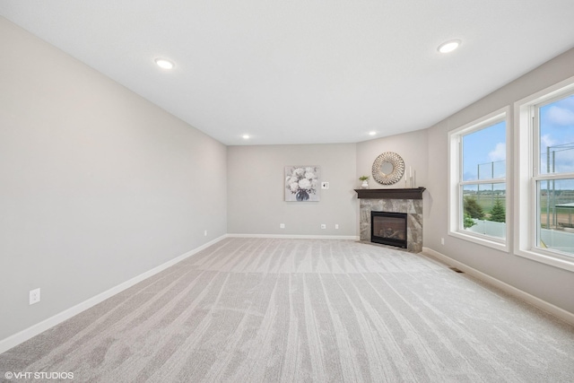 15742 Everglade Ave, Apple Valley, MN 55124 - unfurnished living room with light colored carpet, a tiled fireplace, and recessed lighting