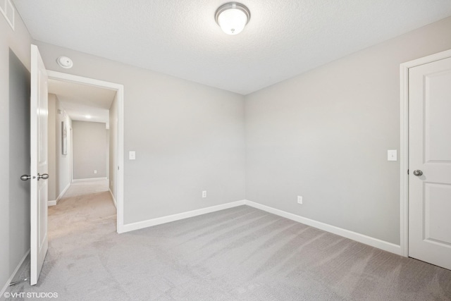 15742 Everglade Ave, Apple Valley, MN 55124 - unfurnished room featuring light colored carpet, a smoke detector, and a textured ceiling