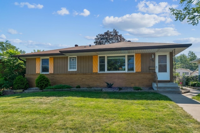 3355 Central Ave NE, Minneapolis, MN 55418 - view of front of home with brick siding, a front yard, and board and batten siding