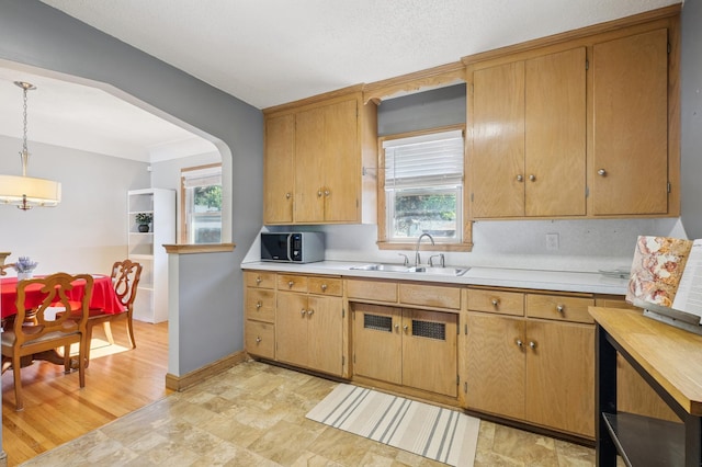 3355 Central Ave NE, Minneapolis, MN 55418 - kitchen with light countertops, black microwave, decorative light fixtures, and stone finish flooring