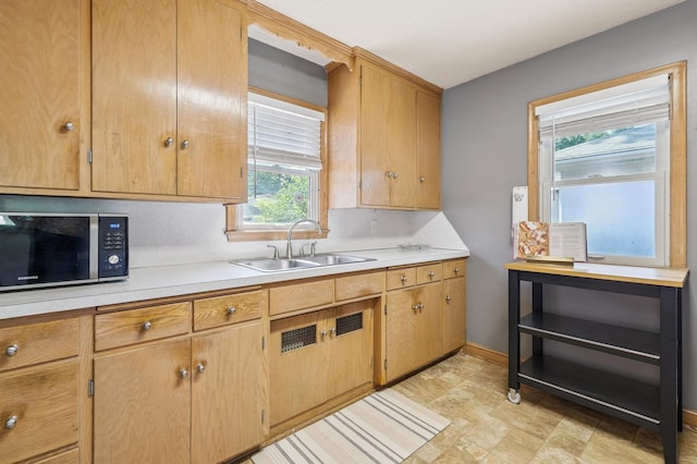 3355 Central Ave NE, Minneapolis, MN 55418 - kitchen with stainless steel microwave, light countertops, and stone finish floors