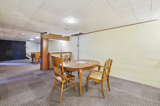 3355 Central Ave NE, Minneapolis, MN 55418 - dining space with carpet floors and concrete block wall