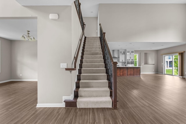 5370 Fountain Ln N, Plymouth, MN 55446 - staircase featuring wood finished floors and a chandelier