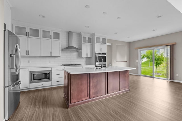 5370 Fountain Ln N, Plymouth, MN 55446 - kitchen with appliances with stainless steel finishes, wall chimney exhaust hood, dark wood-type flooring, light countertops, and backsplash