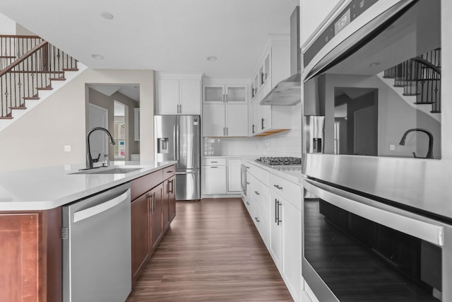 5370 Fountain Ln N, Plymouth, MN 55446 - kitchen with stainless steel appliances, wall chimney range hood, light countertops, glass insert cabinets, and dark wood-style flooring