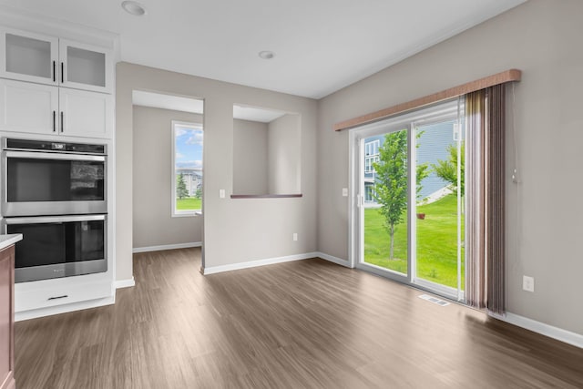 5370 Fountain Ln N, Plymouth, MN 55446 - kitchen with stainless steel double oven, healthy amount of natural light, and wood finished floors