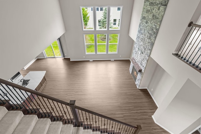 5370 Fountain Ln N, Plymouth, MN 55446 - stairway with wood finished floors, a stone fireplace, and a high ceiling