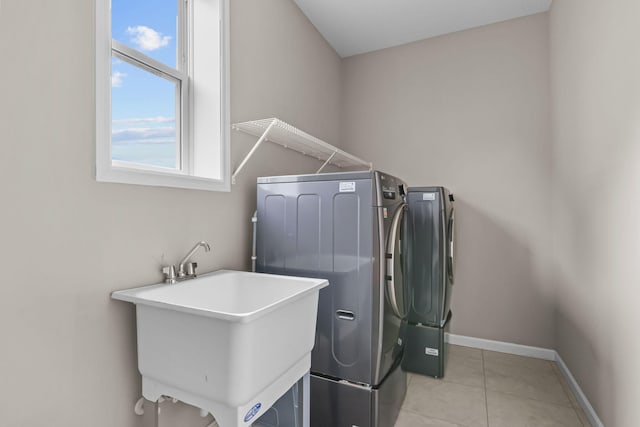 5370 Fountain Ln N, Plymouth, MN 55446 - washroom featuring washing machine and dryer and light tile patterned floors