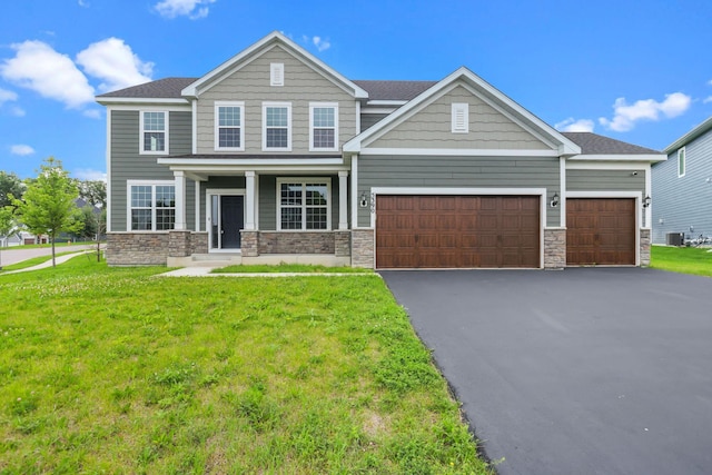 5390 Everest Ln N, Plymouth, MN 55446 - craftsman house featuring stone siding, a garage, driveway, and a front lawn