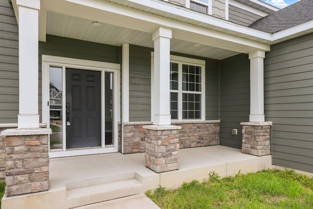 5390 Everest Ln N, Plymouth, MN 55446 - entrance to property featuring covered porch, stone siding, and a shingled roof