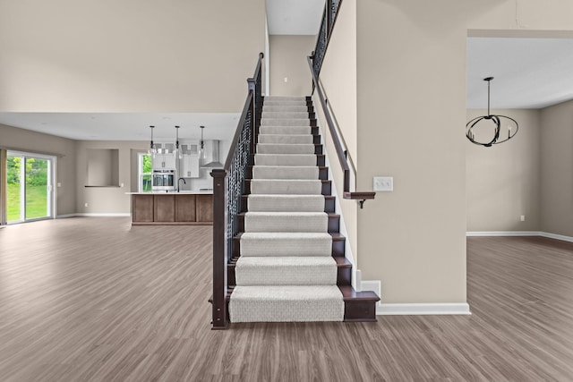 5390 Everest Ln N, Plymouth, MN 55446 - stairs with wood finished floors and a chandelier
