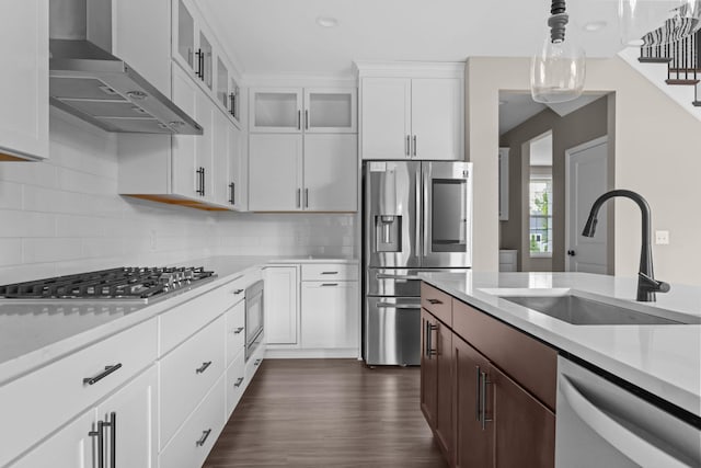 5390 Everest Ln N, Plymouth, MN 55446 - kitchen featuring appliances with stainless steel finishes, wall chimney exhaust hood, light countertops, glass insert cabinets, and recessed lighting