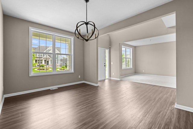 5390 Everest Ln N, Plymouth, MN 55446 - spare room featuring dark wood-type flooring and a chandelier