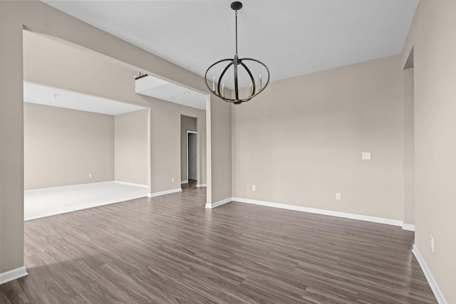 5390 Everest Ln N, Plymouth, MN 55446 - empty room featuring a chandelier and dark wood-style flooring