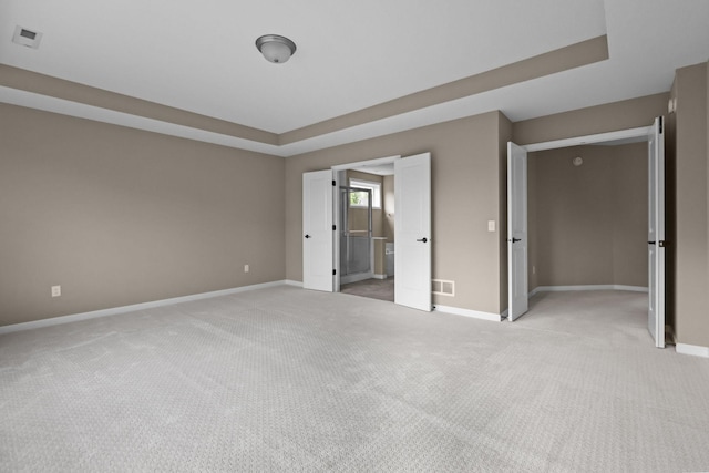 5390 Everest Ln N, Plymouth, MN 55446 - unfurnished bedroom featuring light colored carpet and a tray ceiling