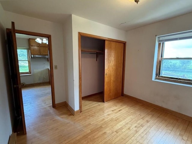 2999 18th St, Oak Grove Twp, WI 54868 - unfurnished bedroom featuring light wood-style flooring and a closet