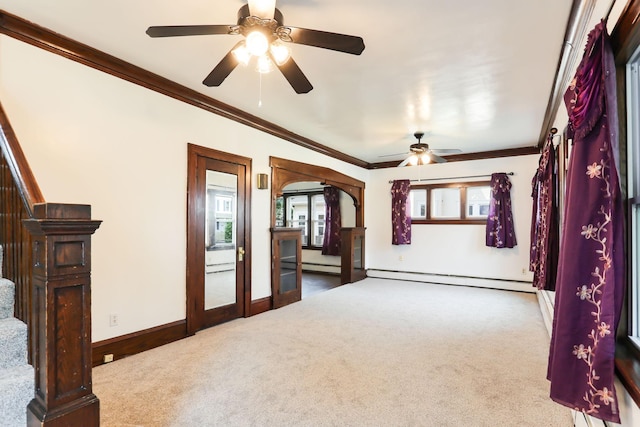 2707 Girard Ave N, Minneapolis, MN 55411 - carpeted empty room with baseboard heating, plenty of natural light, a ceiling fan, crown molding, and arched walkways