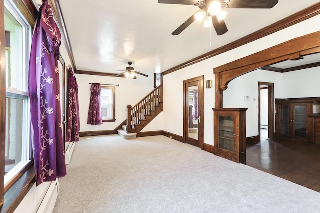 2707 Girard Ave N, Minneapolis, MN 55411 - empty room with a ceiling fan, crown molding, carpet, stairway, and a baseboard heating unit