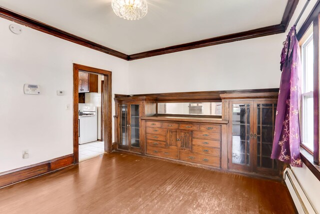 2707 Girard Ave N, Minneapolis, MN 55411 - unfurnished living room with a baseboard heating unit, crown molding, wood finished floors, plenty of natural light, and a chandelier