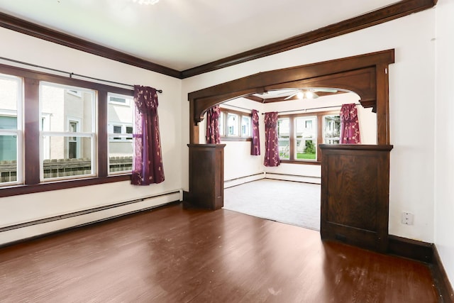 2707 Girard Ave N, Minneapolis, MN 55411 - empty room with a baseboard radiator, wood finished floors, ornamental molding, and plenty of natural light