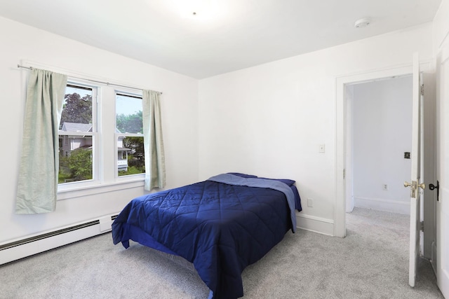 2707 Girard Ave N, Minneapolis, MN 55411 - carpeted bedroom with baseboard heating and baseboards