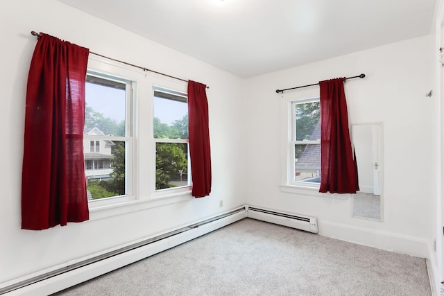 2707 Girard Ave N, Minneapolis, MN 55411 - spare room featuring a baseboard heating unit and carpet floors