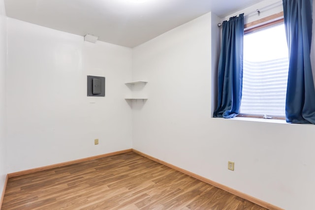 2707 Girard Ave N, Minneapolis, MN 55411 - unfurnished room with light wood-type flooring and electric panel