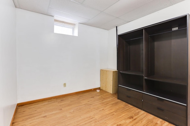 2707 Girard Ave N, Minneapolis, MN 55411 - basement featuring light wood-style flooring and a drop ceiling