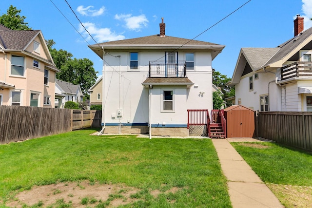 2707 Girard Ave N, Minneapolis, MN 55411 - rear view of property featuring a balcony, stucco siding, a fenced backyard, and a chimney