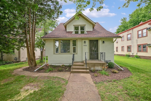 4416 46th Ave S, Minneapolis, MN 55406 - bungalow-style home with roof with shingles, stucco siding, and a front lawn