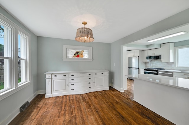 4416 46th Ave S, Minneapolis, MN 55406 - kitchen featuring appliances with stainless steel finishes, dark wood-style flooring, and healthy amount of natural light