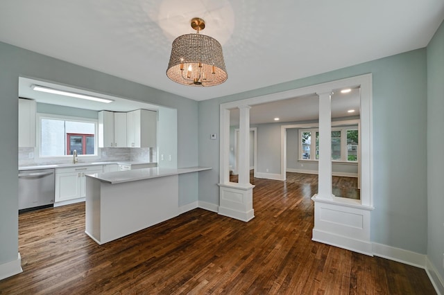 4416 46th Ave S, Minneapolis, MN 55406 - kitchen featuring stainless steel dishwasher, light countertops, white cabinetry, a peninsula, and decorative columns