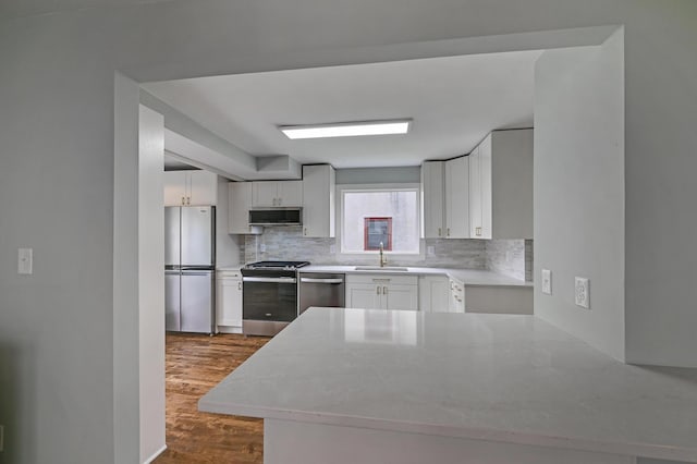 4416 46th Ave S, Minneapolis, MN 55406 - kitchen with stainless steel appliances, tasteful backsplash, white cabinetry, and dark wood-style flooring