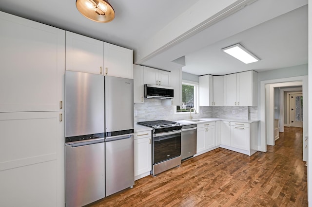 4416 46th Ave S, Minneapolis, MN 55406 - kitchen featuring appliances with stainless steel finishes, backsplash, light countertops, and white cabinetry