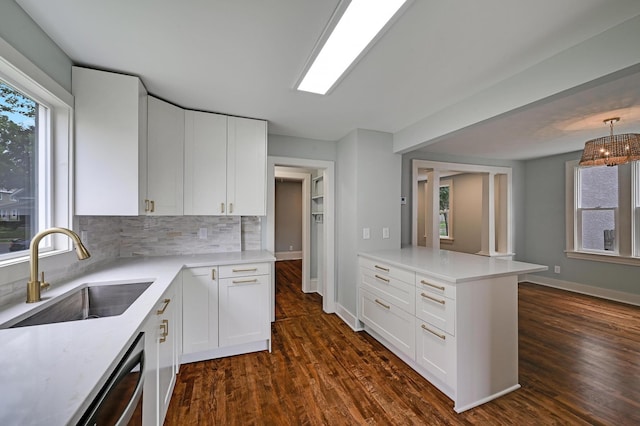 4416 46th Ave S, Minneapolis, MN 55406 - kitchen featuring a peninsula, light countertops, decorative backsplash, and white cabinets