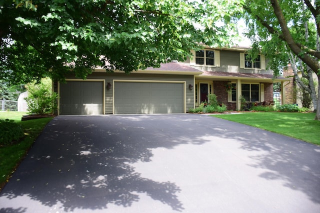 15620 45th Ave N, Plymouth, MN 55446 - view of front of house featuring driveway, a front yard, a garage, and brick siding