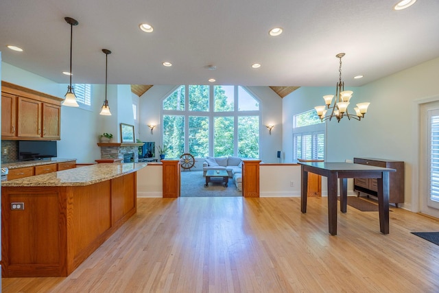 5108 Drummond Rd, Mound, MN 55364 - kitchen featuring brown cabinetry, healthy amount of natural light, light wood-type flooring, high vaulted ceiling, and recessed lighting