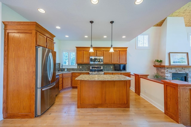 5108 Drummond Rd, Mound, MN 55364 - kitchen with appliances with stainless steel finishes, decorative backsplash, plenty of natural light, a kitchen island, and recessed lighting