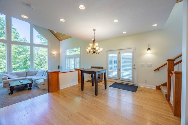 5108 Drummond Rd, Mound, MN 55364 - dining area with a chandelier, recessed lighting, light wood-style floors, stairs, and high vaulted ceiling