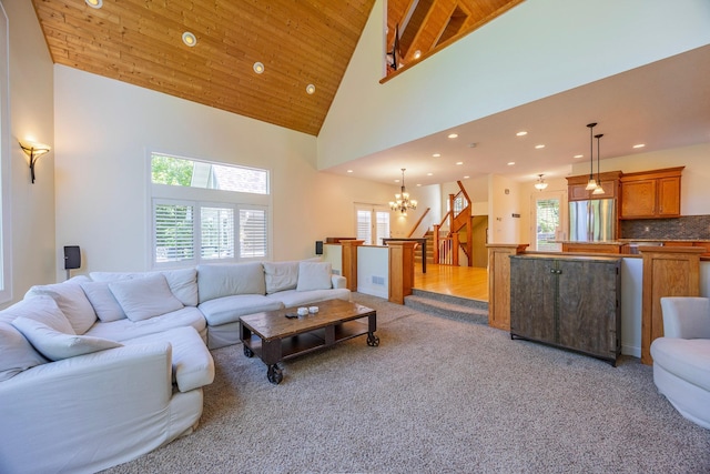 5108 Drummond Rd, Mound, MN 55364 - living room with a chandelier, recessed lighting, light colored carpet, high vaulted ceiling, and stairs