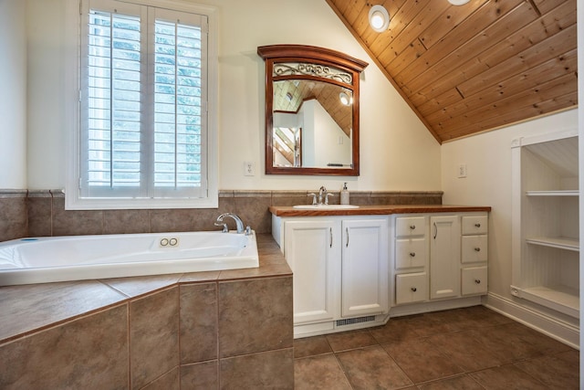 5108 Drummond Rd, Mound, MN 55364 - full bath with vanity, vaulted ceiling, a garden tub, healthy amount of natural light, and tile patterned floors
